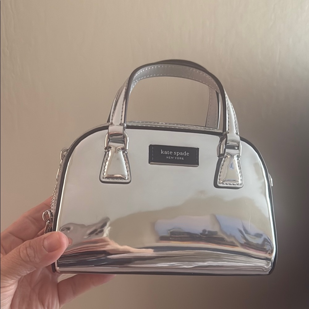 Kate Spade Silver Mini Dome Bag. Bag is 7 x 5 inches. Never used. Black strap